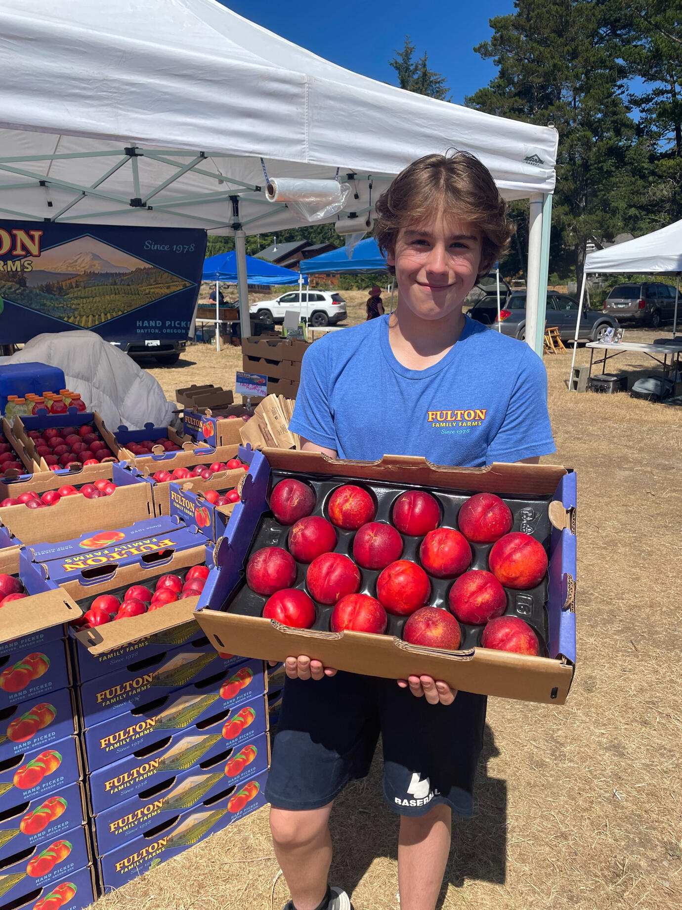Fulton Jr. holding a box of peaches